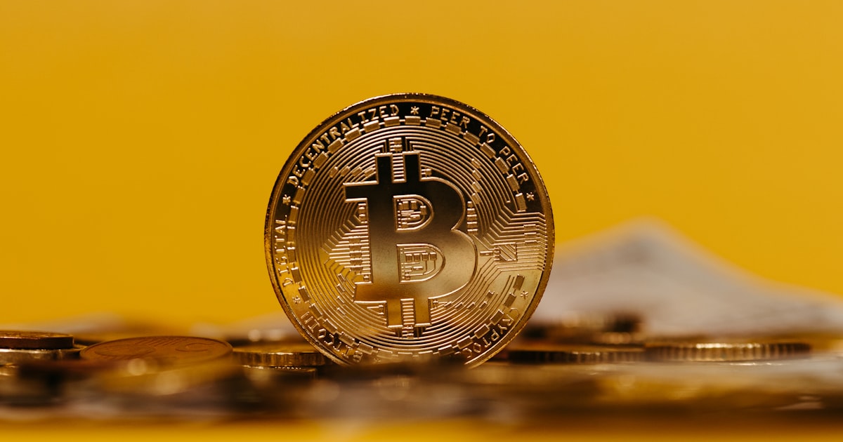 a bit coin sitting on top of a pile of coins