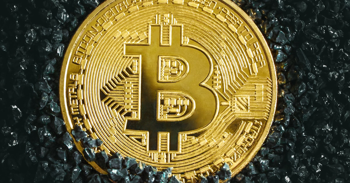 a bitcoin is shown on a black surface