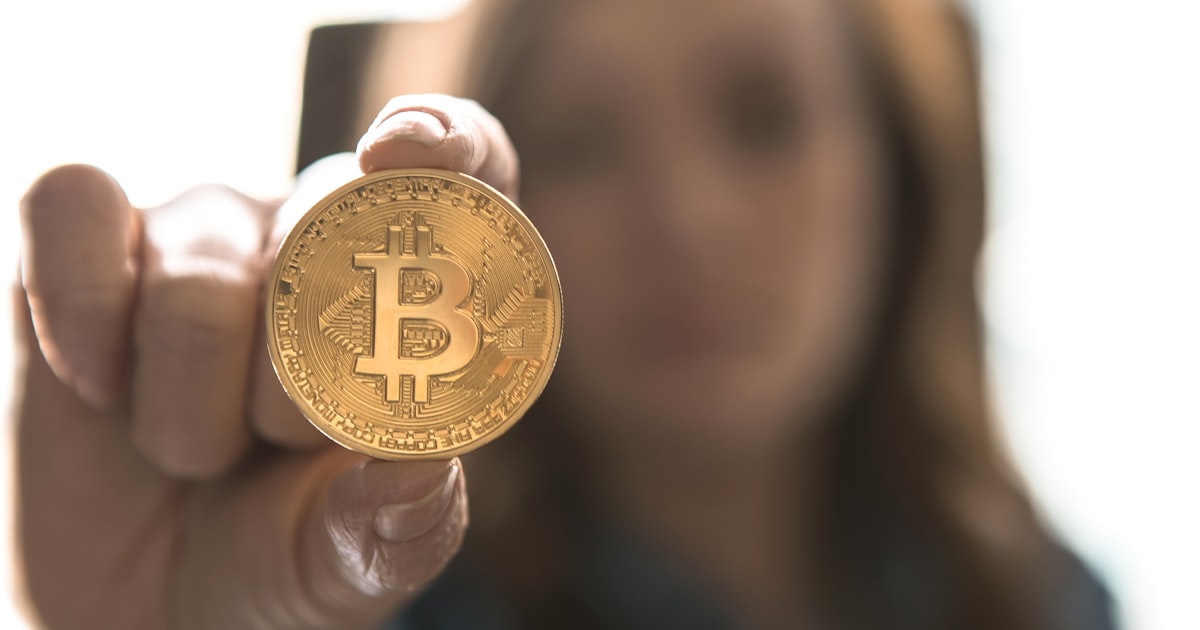 woman holding Bitcoin