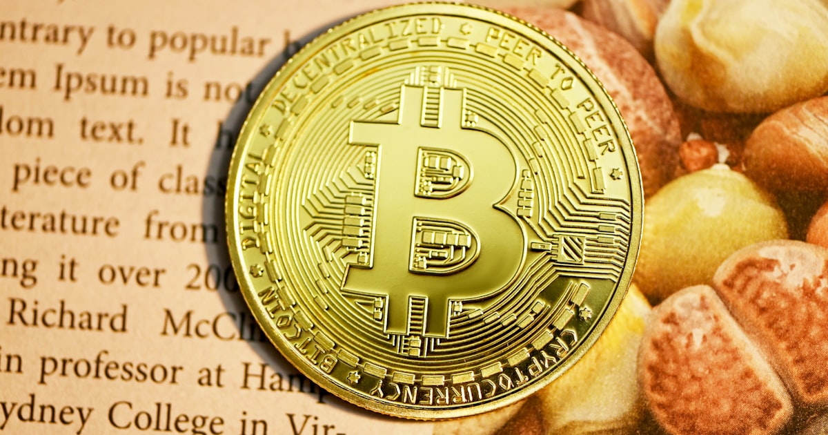 gold round coin on white paper