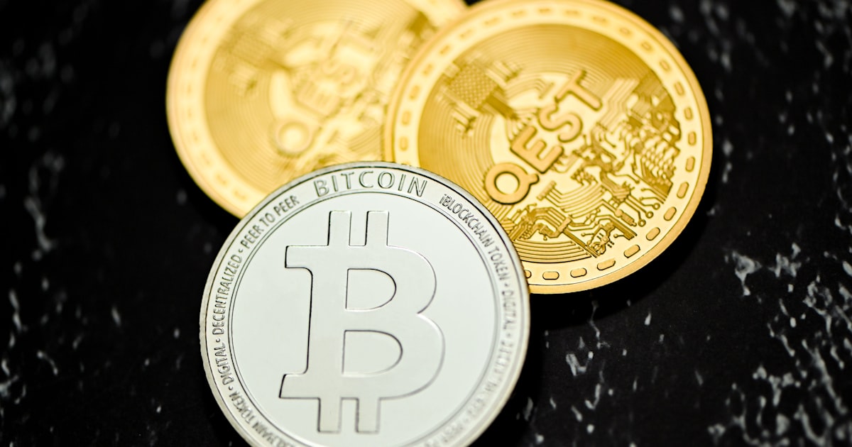 a bitcoin coin sitting on top of a table