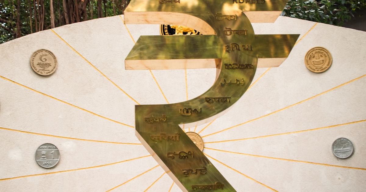 The image shows a large indian rupee symbol.
