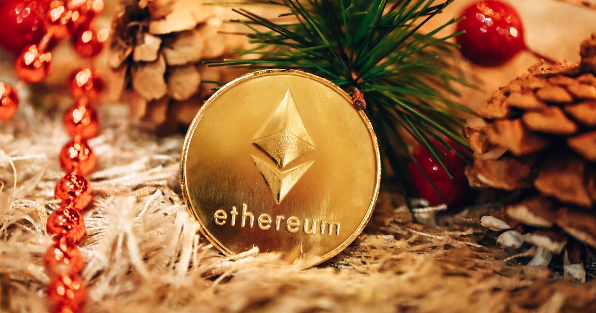 a gold ethereum coin sitting on top of a pile of pine cones