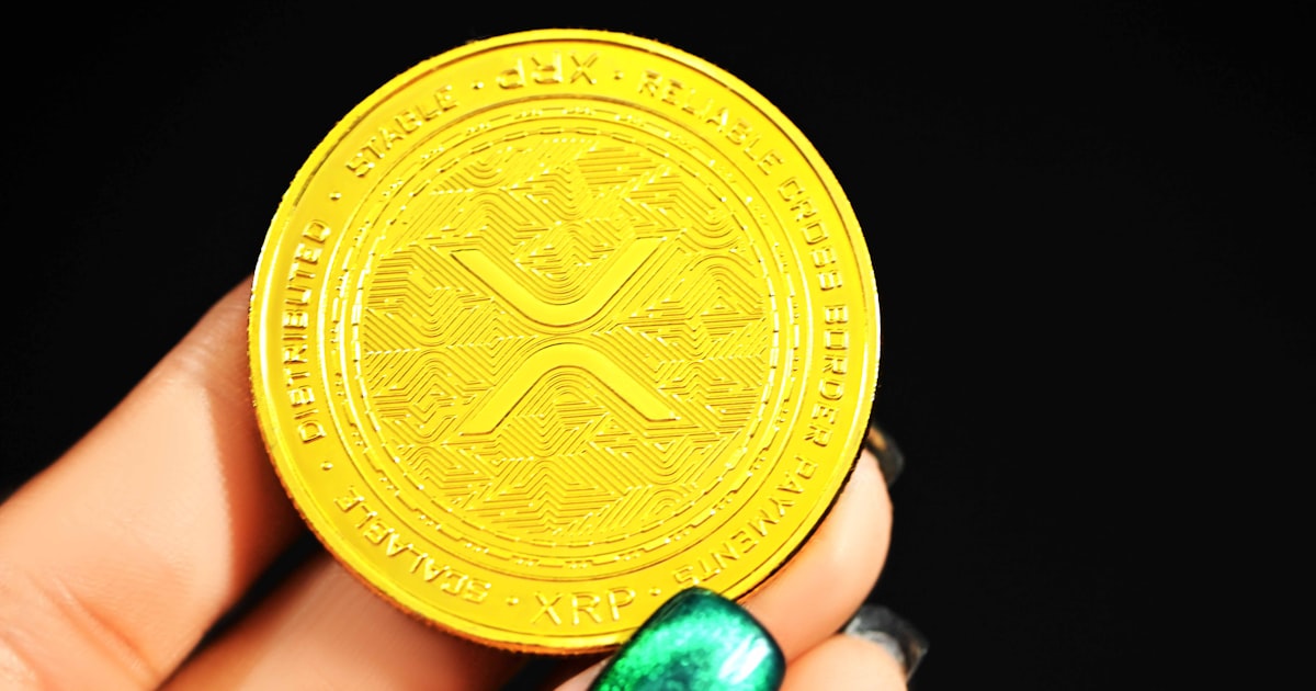 gold round coin on persons hand