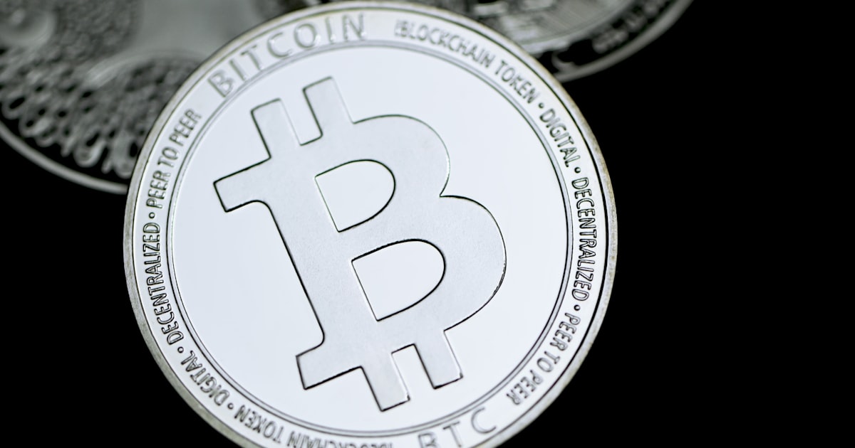 a close up of a bit coin on a black background