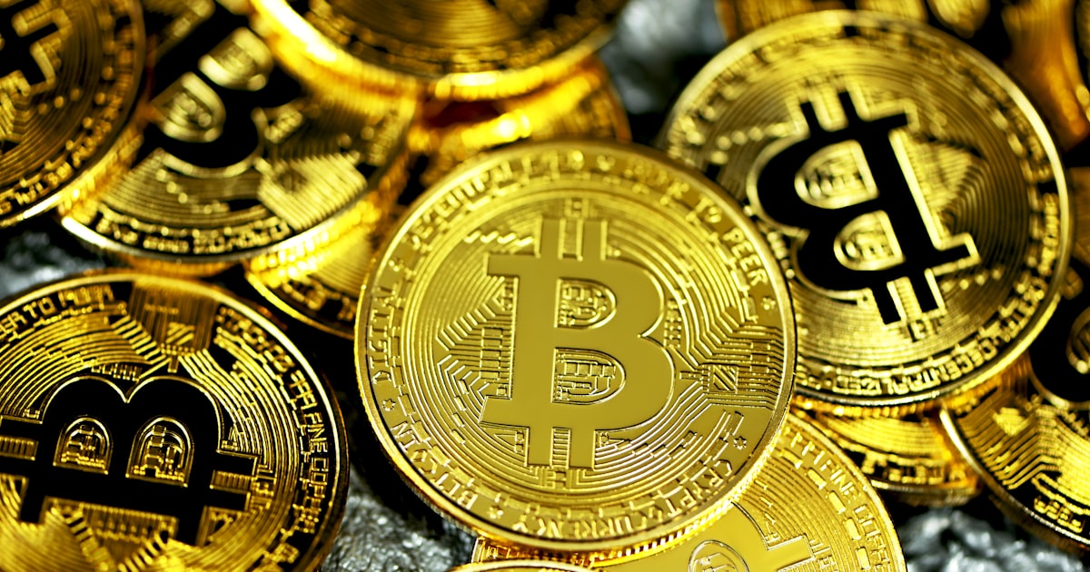 a pile of gold bitcoins sitting next to each other