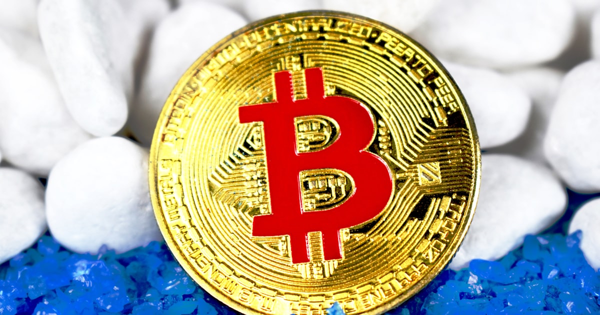 round gold-colored and red Bitcoin coin