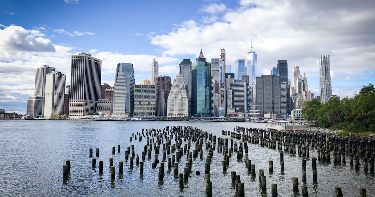 a large body of water with a city in the background