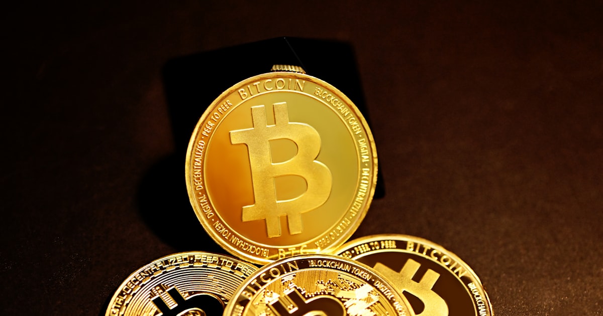 three gold bitcoins sitting on top of each other