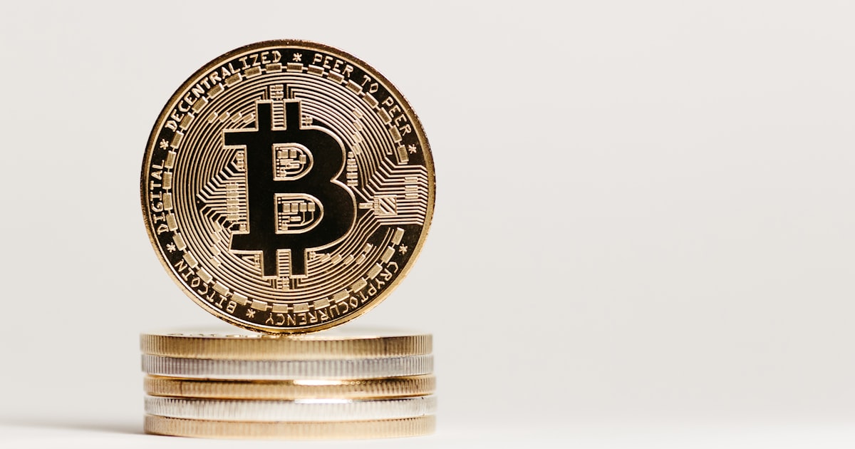 a stack of coins with a bit coin on top