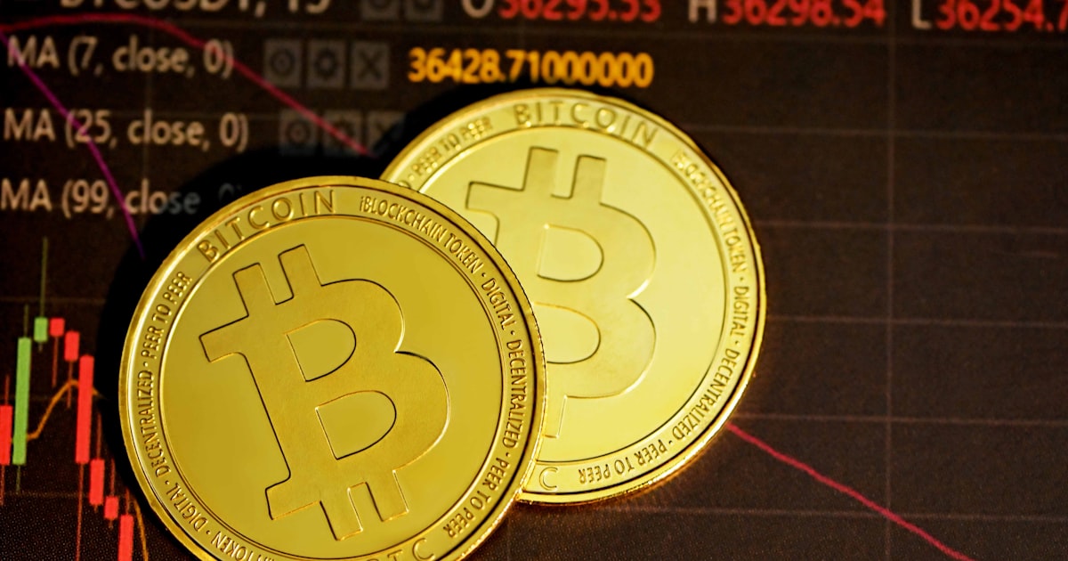 gold round coin on black surface