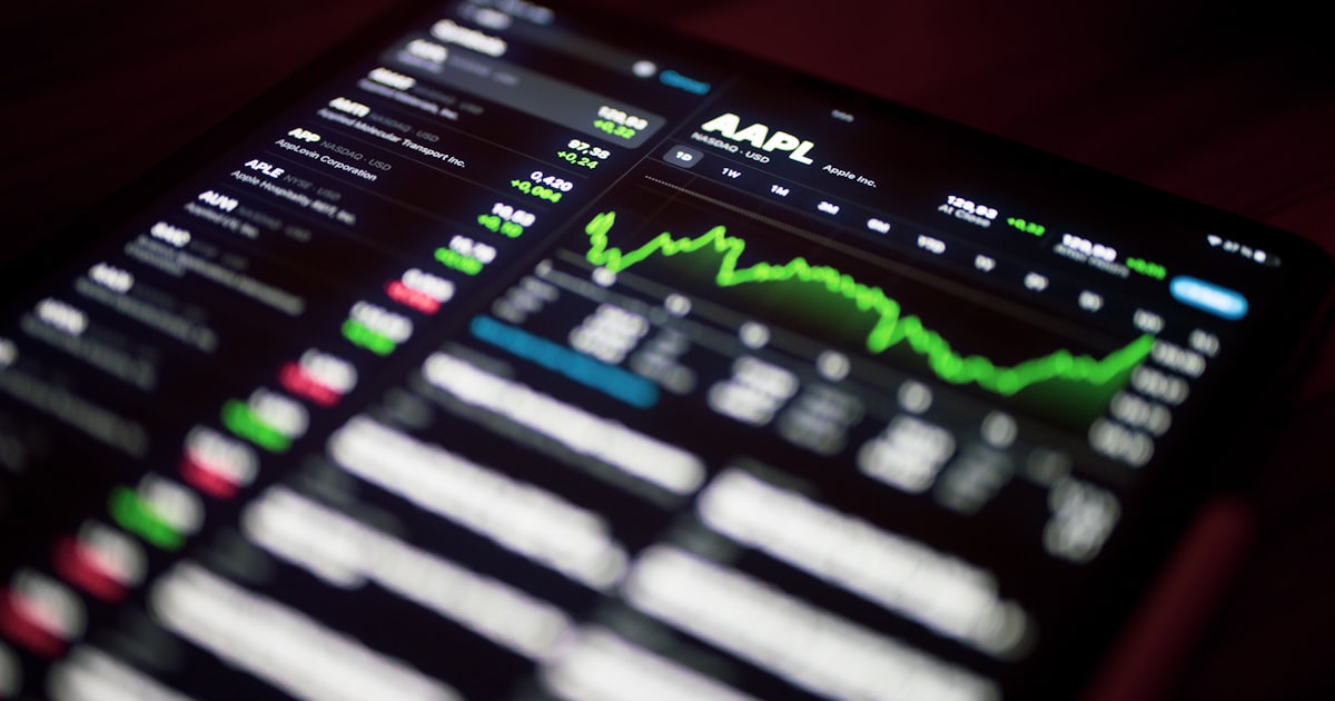 a close up of a cell phone with a stock chart on it