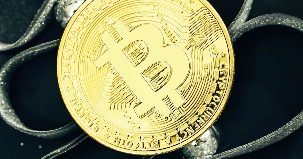 a bit coin sitting on top of a black table