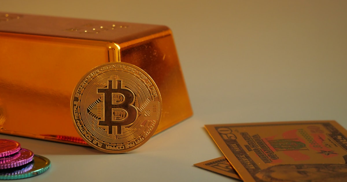 Bitcoin coin with gold bar and currency notes.