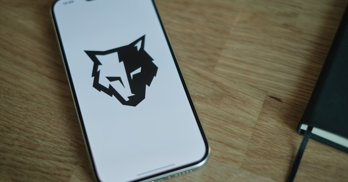 A phone sitting on a table with a logo on it