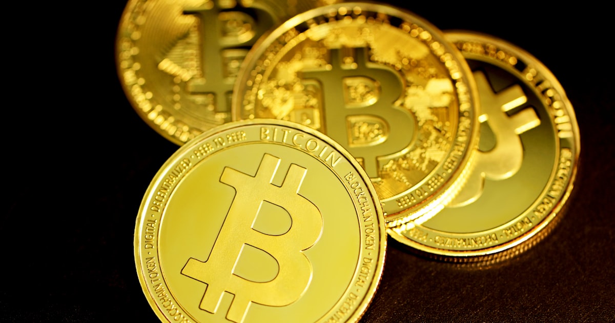 a group of gold bitcoins sitting on top of a table