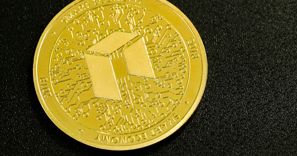 a close up of a gold coin on a black surface