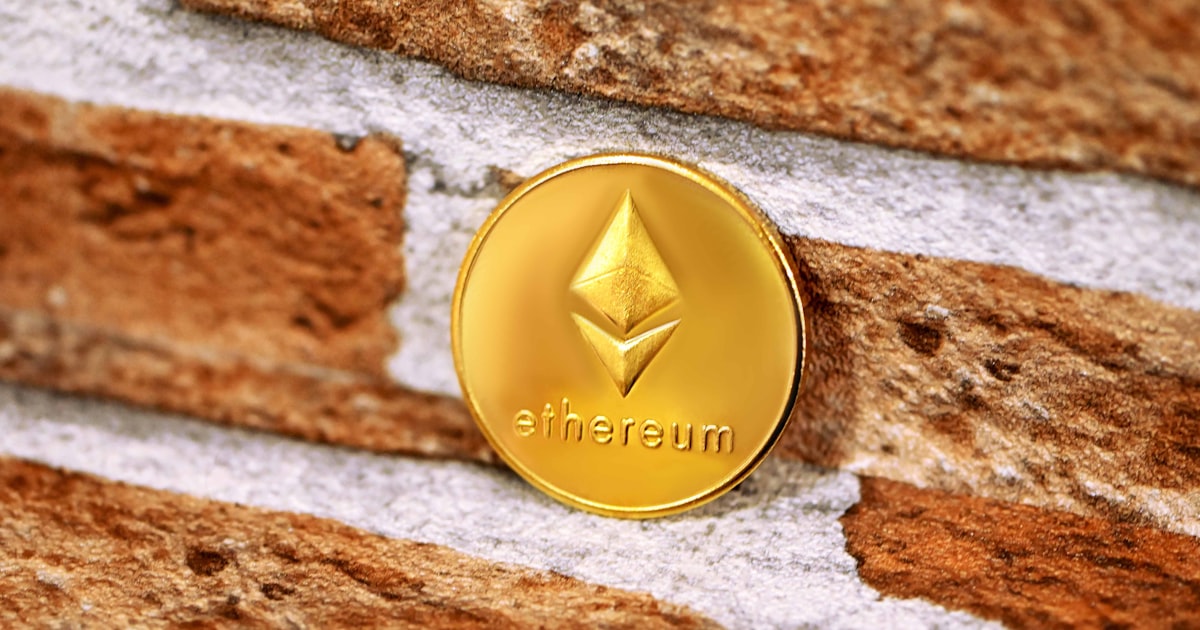 a gold coin sitting on top of a brick wall