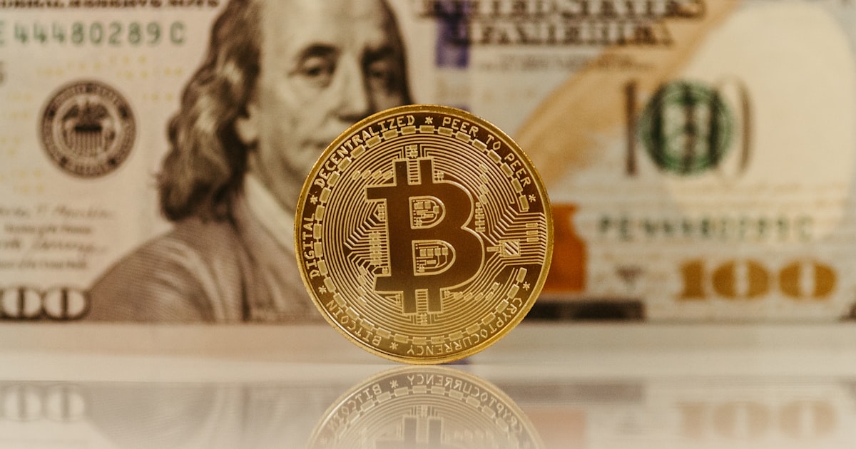 a bitcoin sitting on top of a pile of money