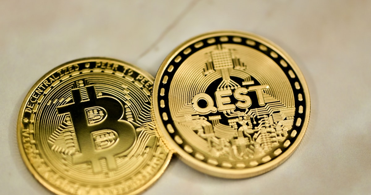 two bitcoins sitting side by side on a table