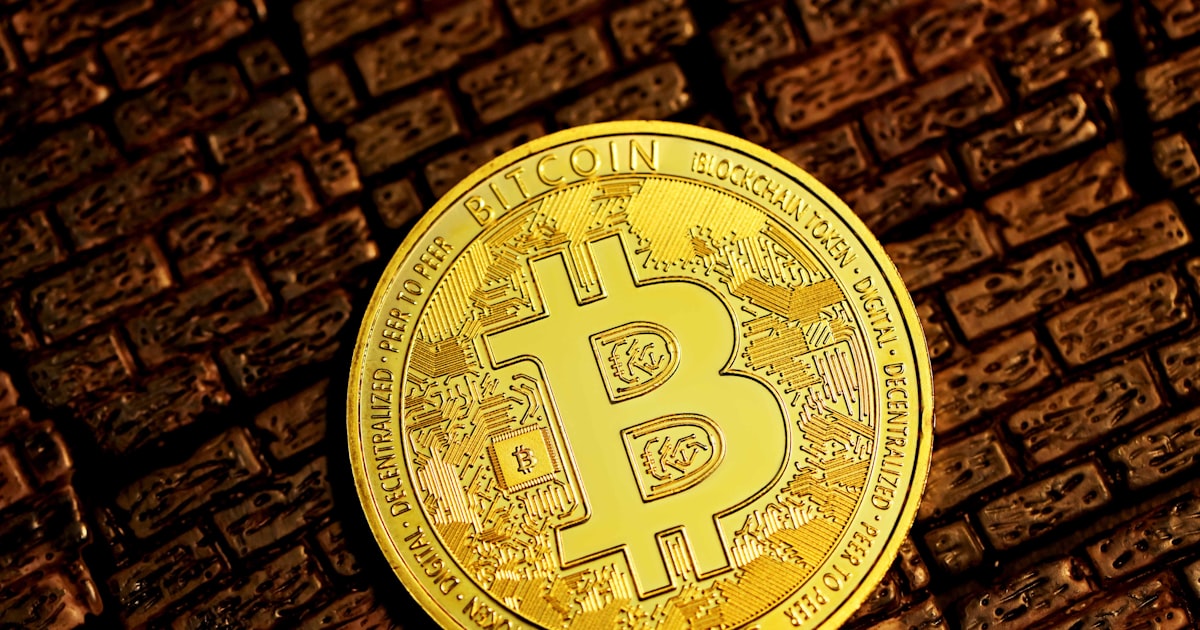 gold round coin on brown textile