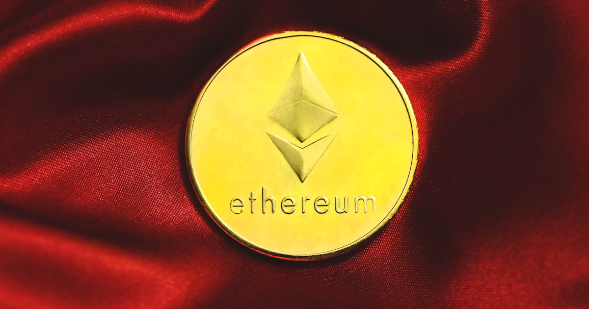 a close up of a gold coin on a red cloth