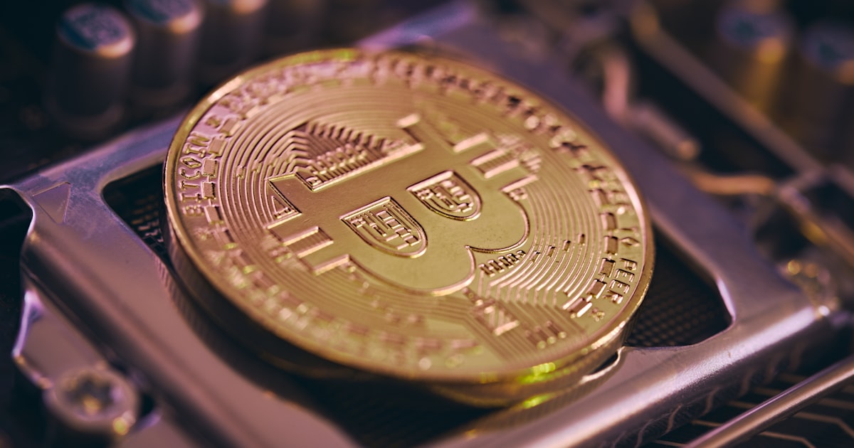 a bit coin sitting on top of a computer processor