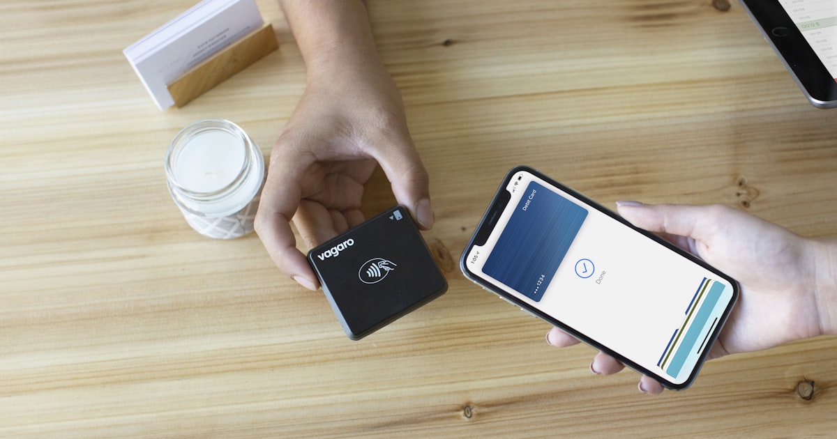 a person holding a wallet and a cell phone