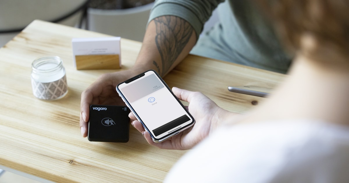 a person sitting at a table with a cell phone