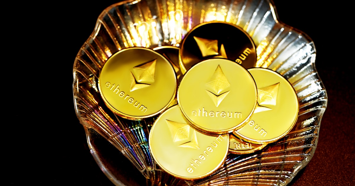 gold and silver round coins on clear glass bowl