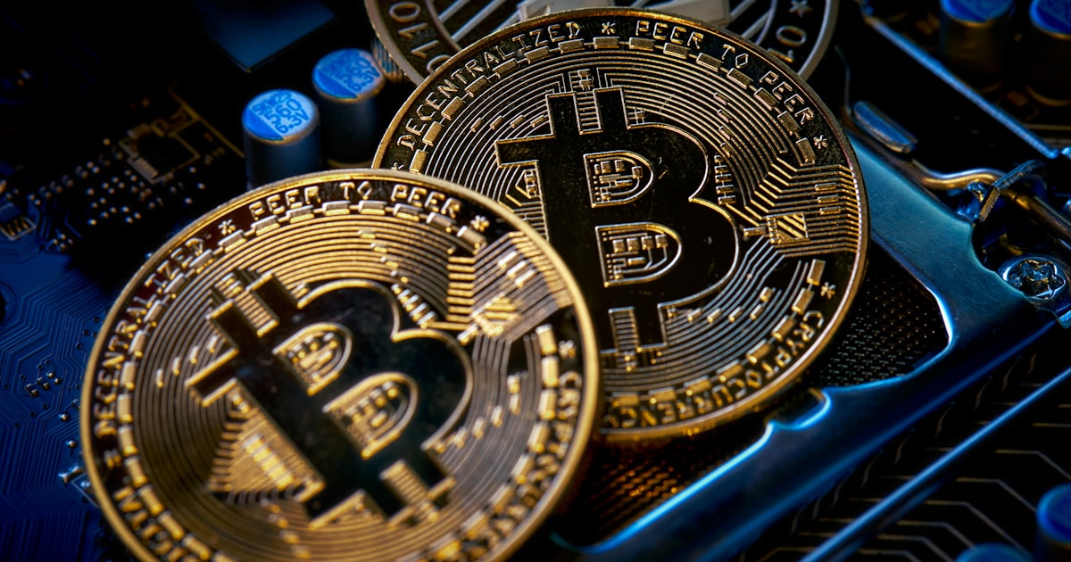 three bitcoins sitting on top of a computer motherboard