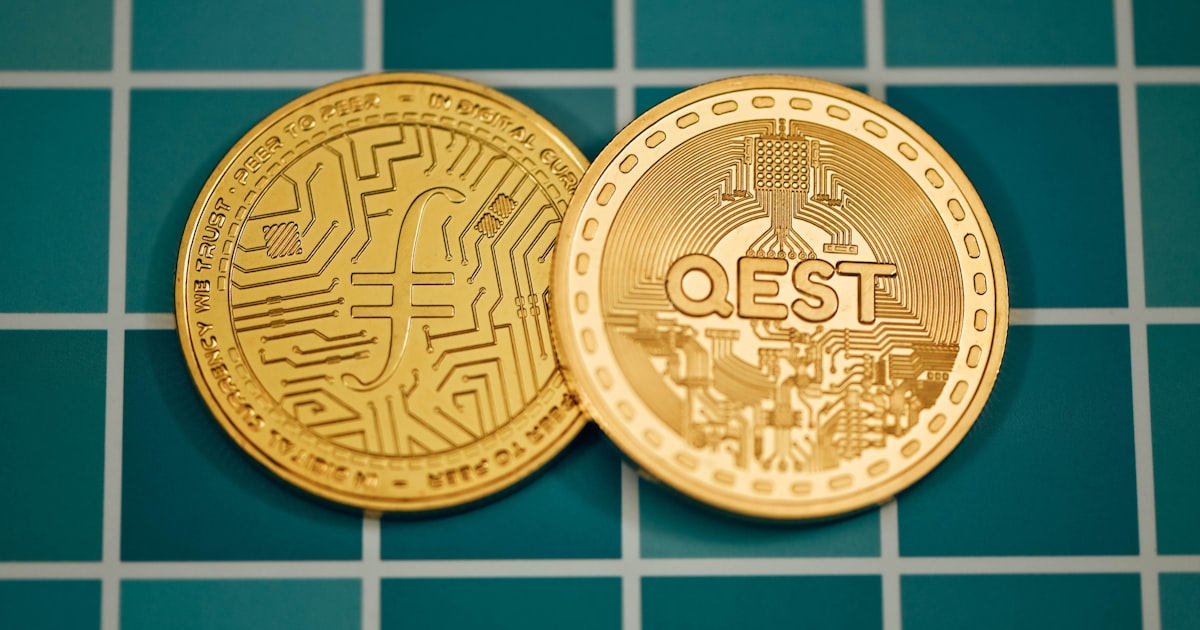 a close up of two gold coins on a tiled surface