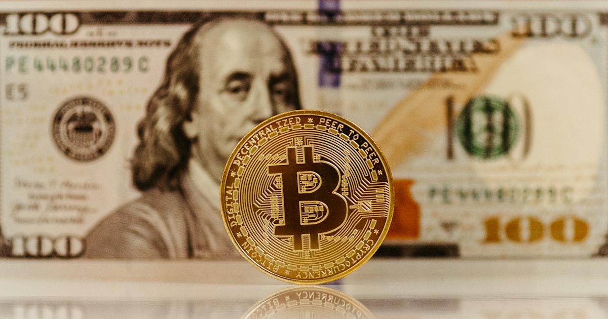 a bitcoin sitting on top of a pile of money
