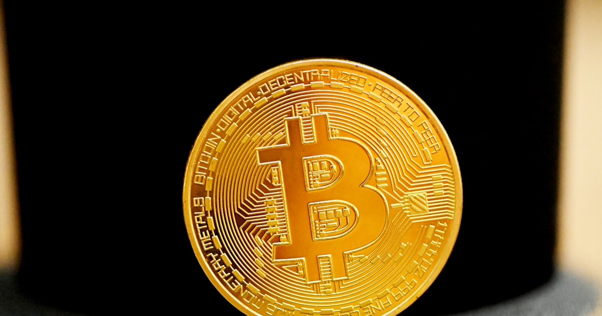 gold round coin on black textile