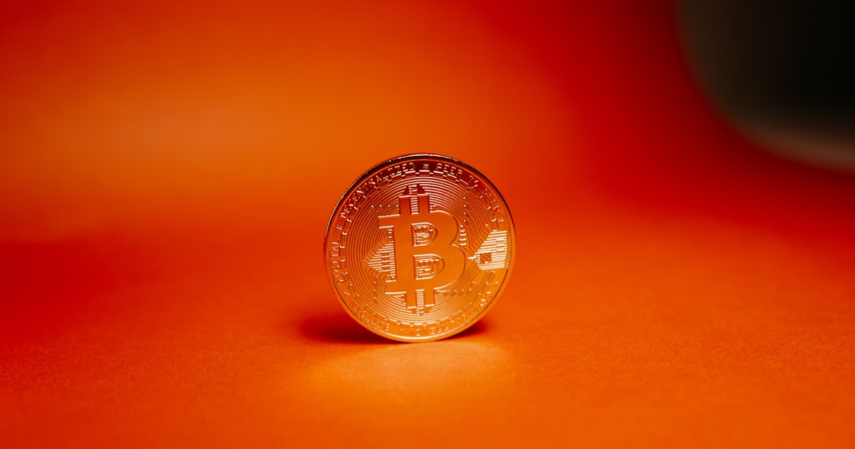 a gold coin on a red surface