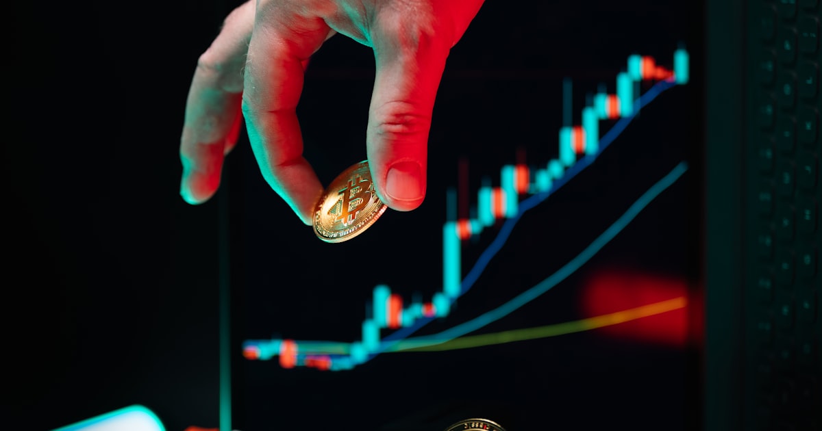 A hand reaching for a coin on a computer keyboard
