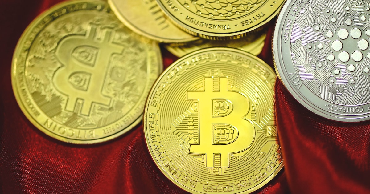 a pile of bitcoins sitting on top of a red cloth