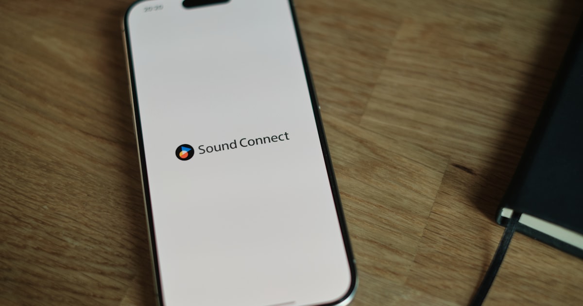 A cell phone sitting on top of a wooden table