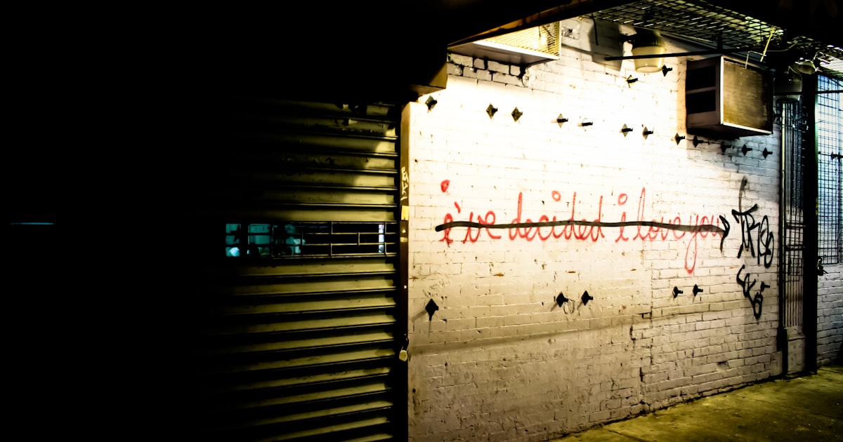 a white brick wall with graffiti on it