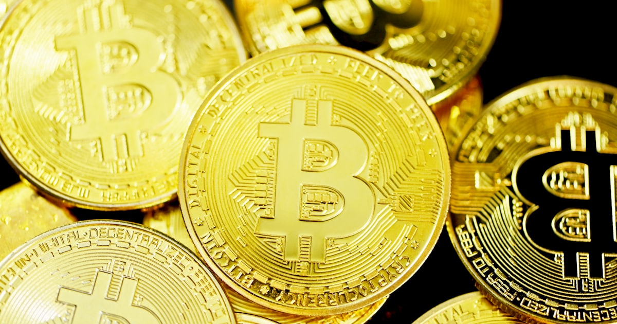 gold round coins on brown wooden table