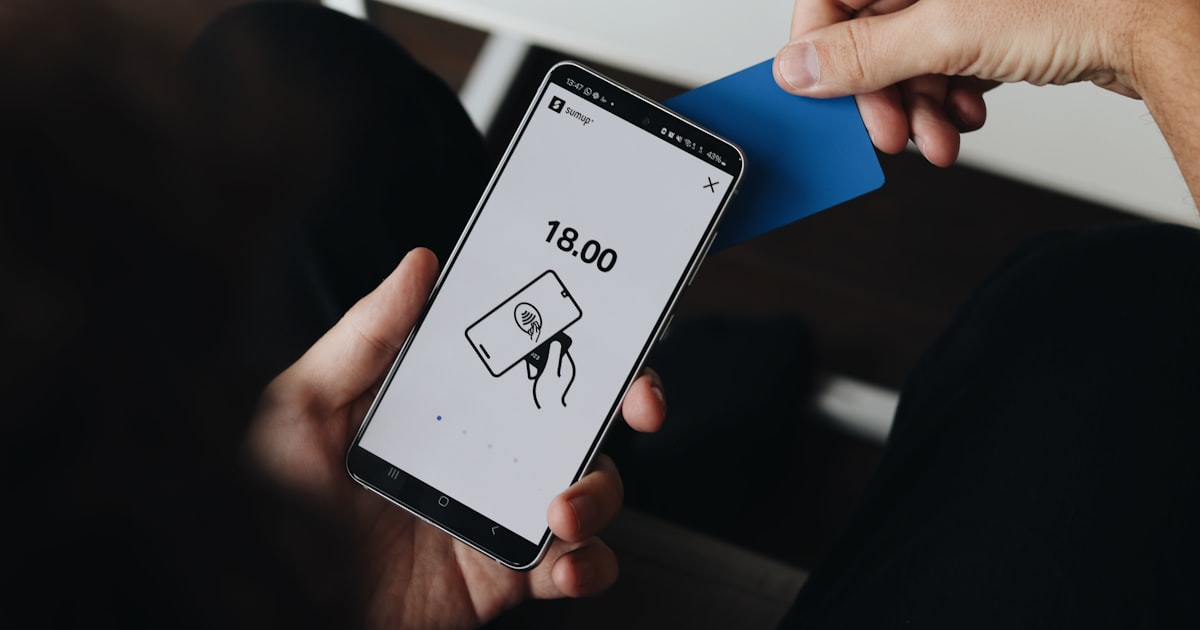 A person holding a cell phone in their hand