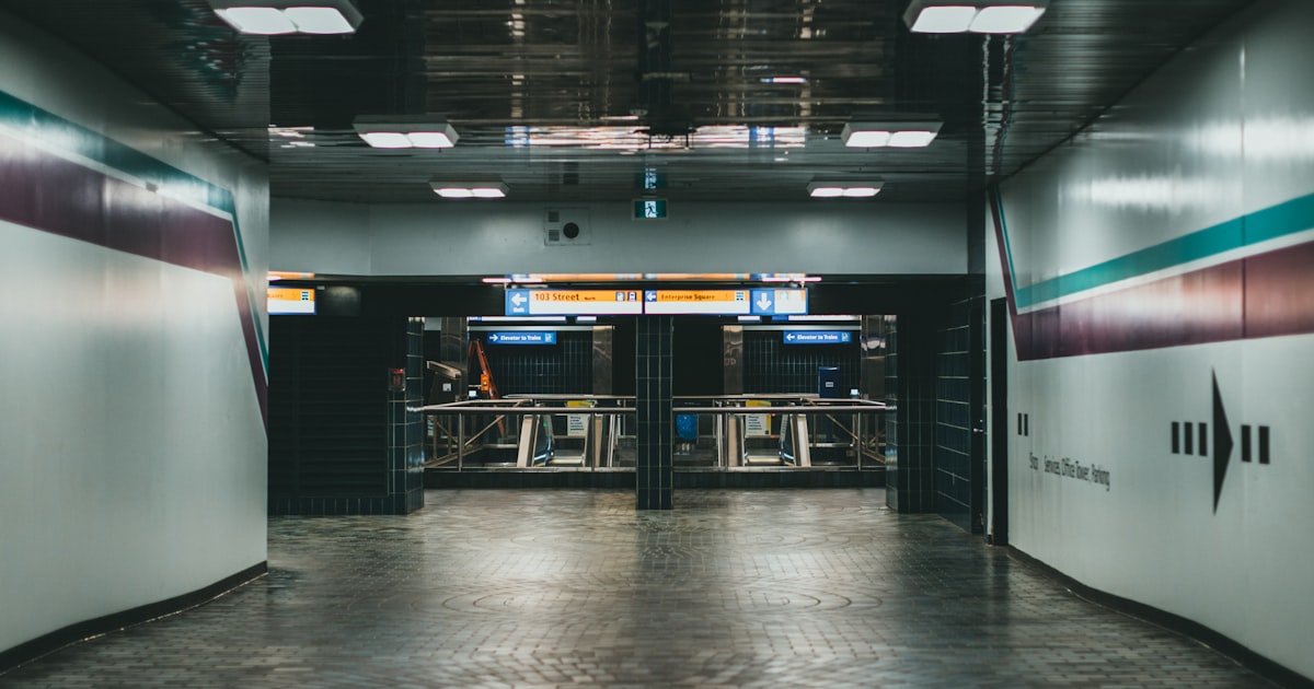 a long hallway with two doors leading to another room