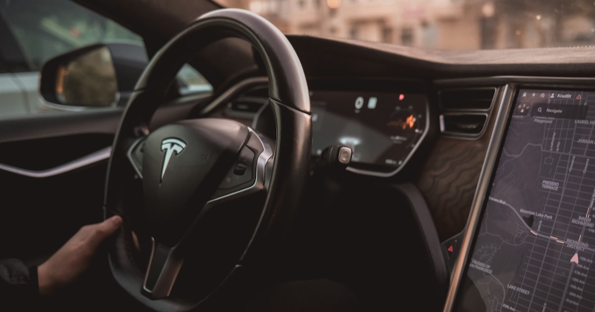 a person driving a car with a dashboard and a monitor