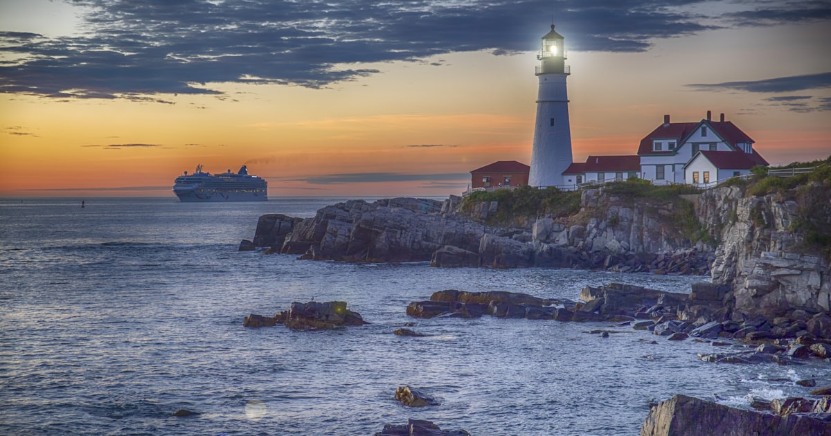 red and white lighthouse on cliff