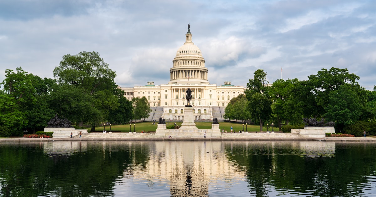 The capitol building is reflected in the water