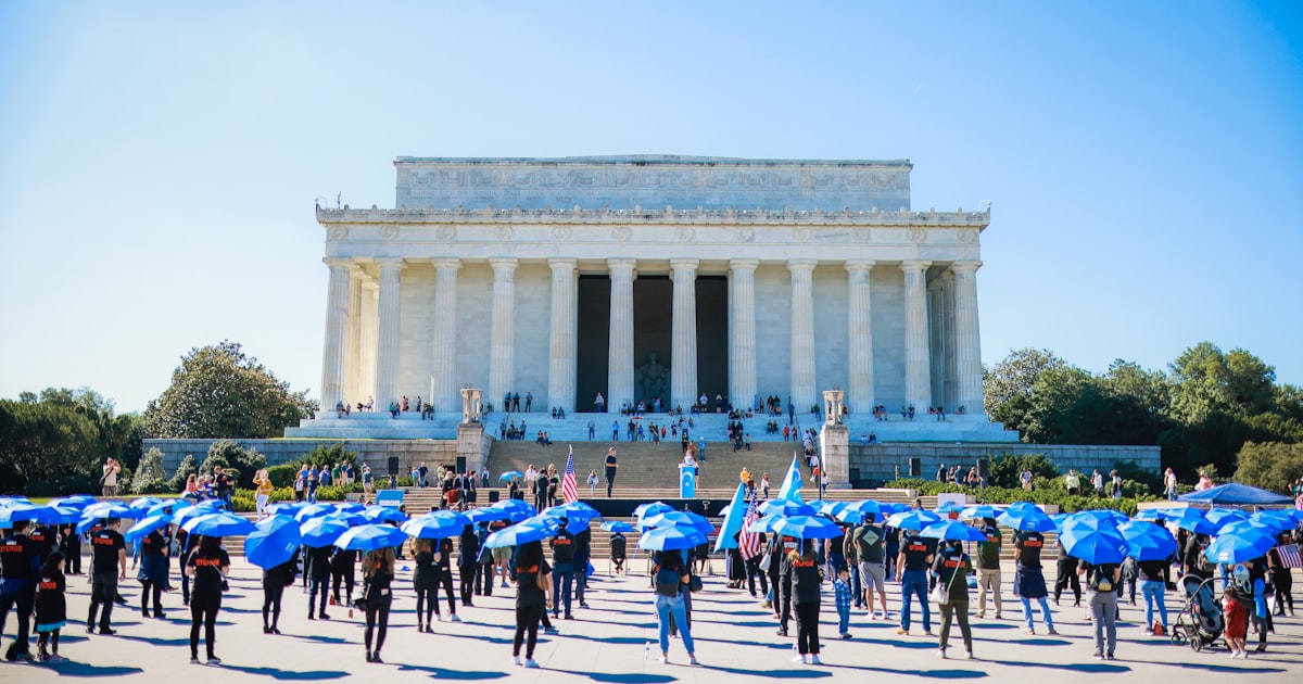 a group of people with umbrellas standing in front of a building