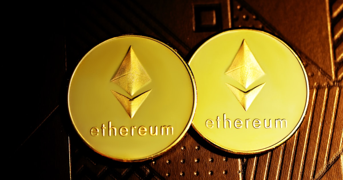 a close up of two gold coin with the word ether on it