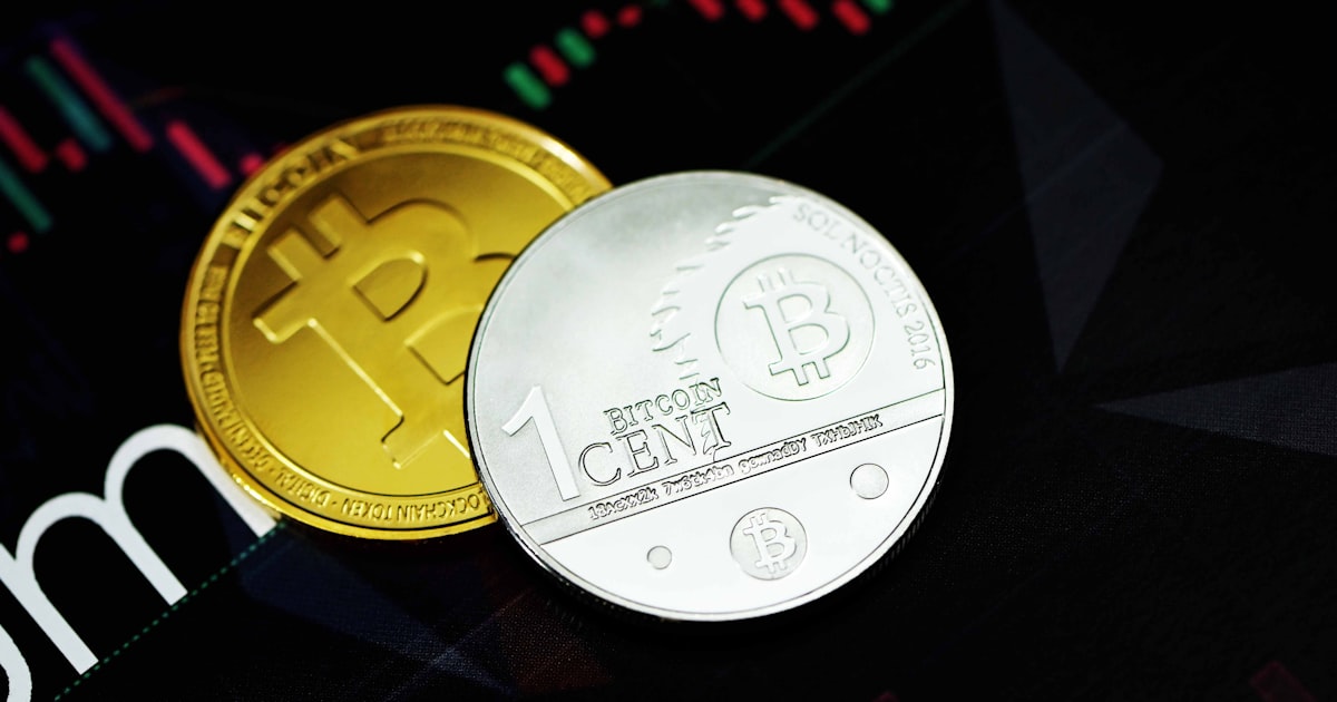 gold round coin on black surface