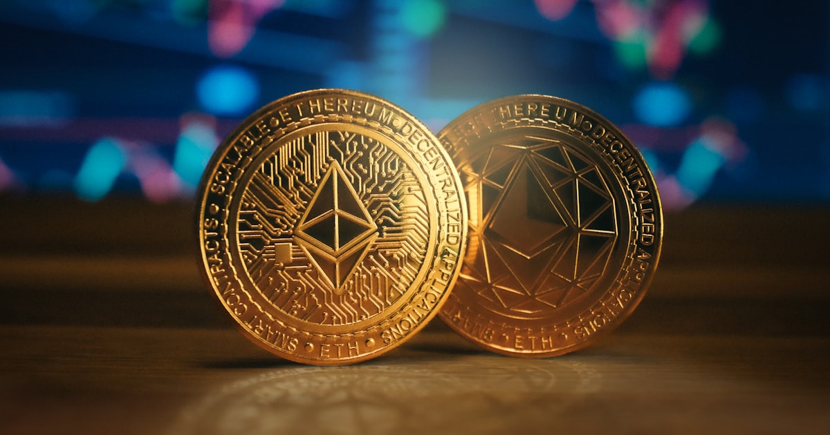 two gold coin sitting on top of a wooden table