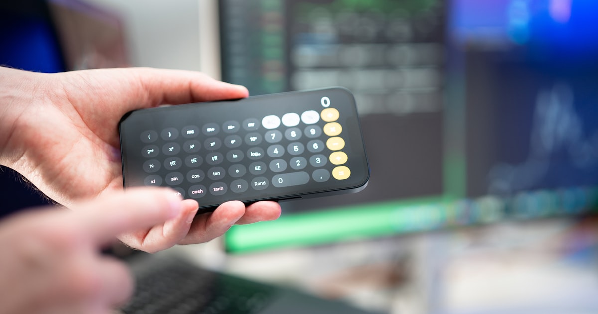 a person holding a remote control in their hand